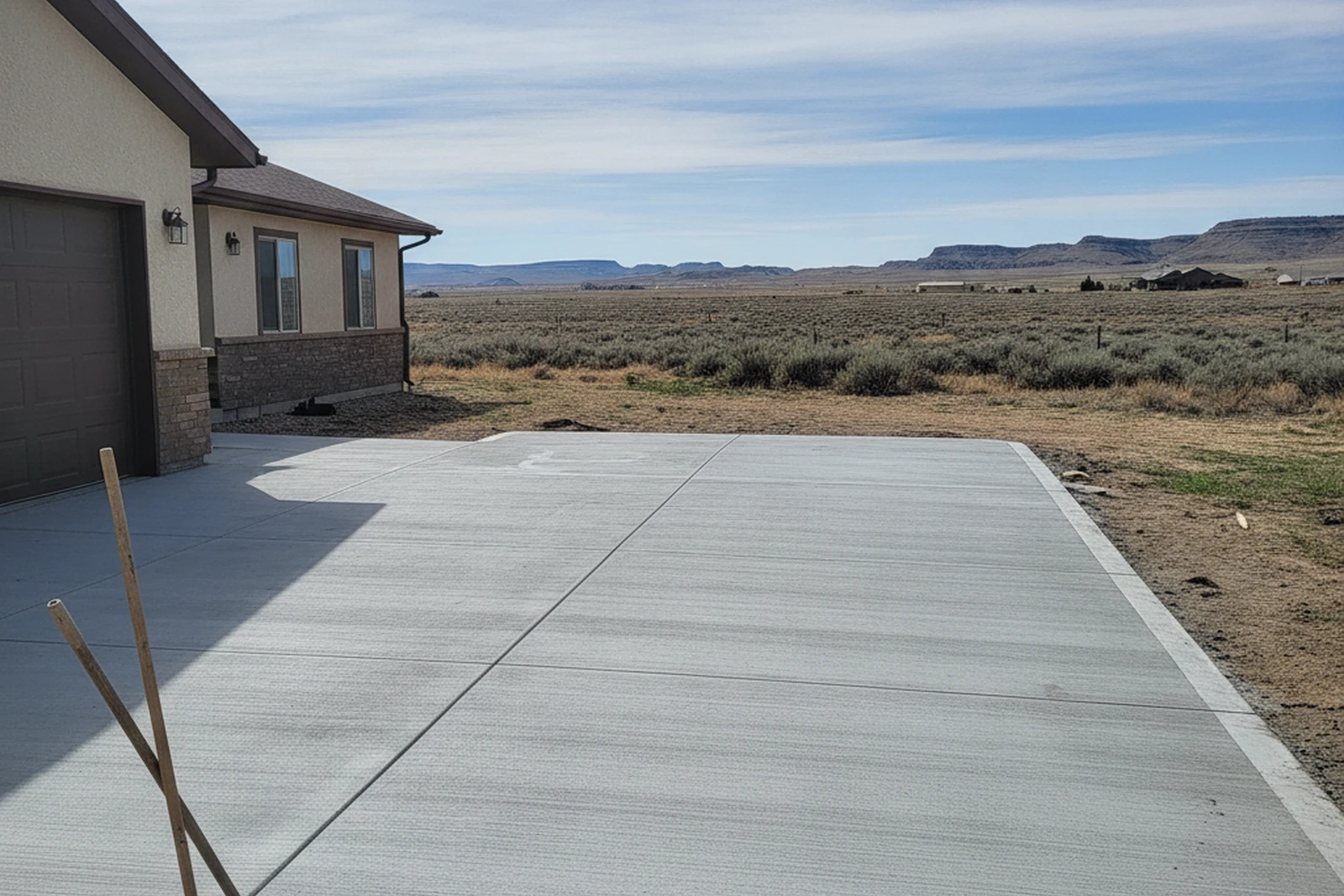 Completed concrete driveway replacement Rock Springs Wyoming Sweetwater County high desert residential broom finish control joints